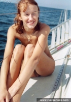 Naked teen redhead posing on yacht
