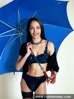 Teen posing with umbrella and stockings