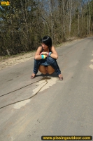 Outdoor pissing on asphalt path