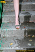 Outdoor pissing of teen brunette on a concrete park ladder