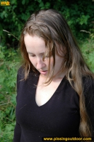 Teen blonde pissing outdoor on the bench in a park