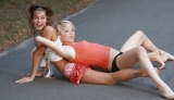 Two laszive girls are playing on the road