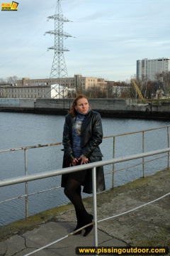 Pissing on the bridge over river - N