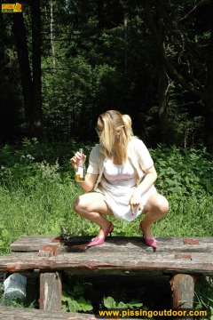 Pissing outdoor deep in the forest on the old table - N