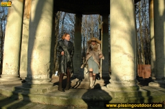 Two girls outdoor pissing on stone columns - N