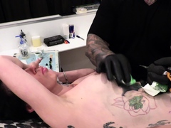 Marie Bossette gets a rose tattooed on her rib