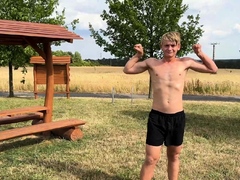 Cute teen blonde boy shows off his abs